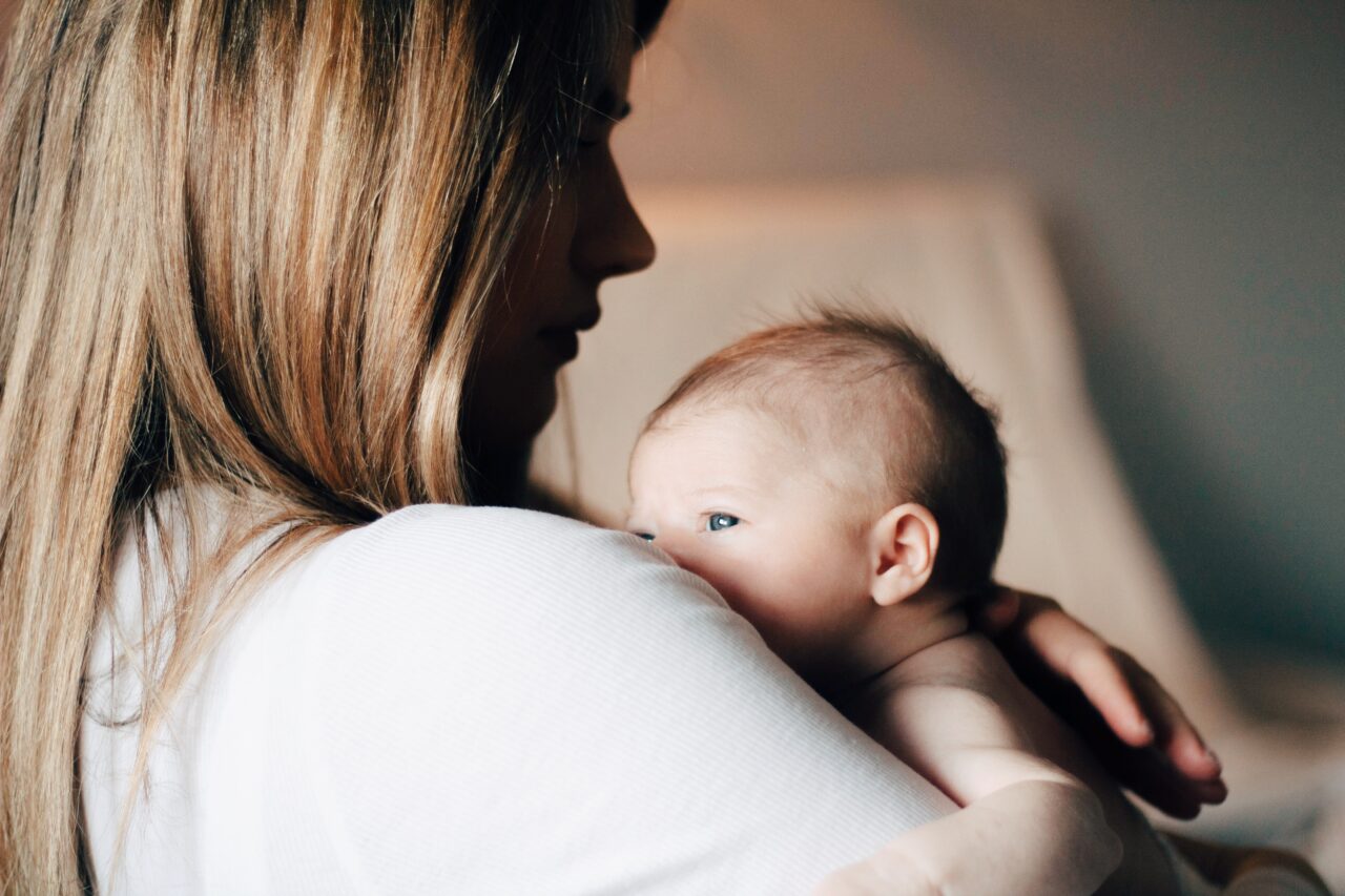 Young mother holding her newborn baby.